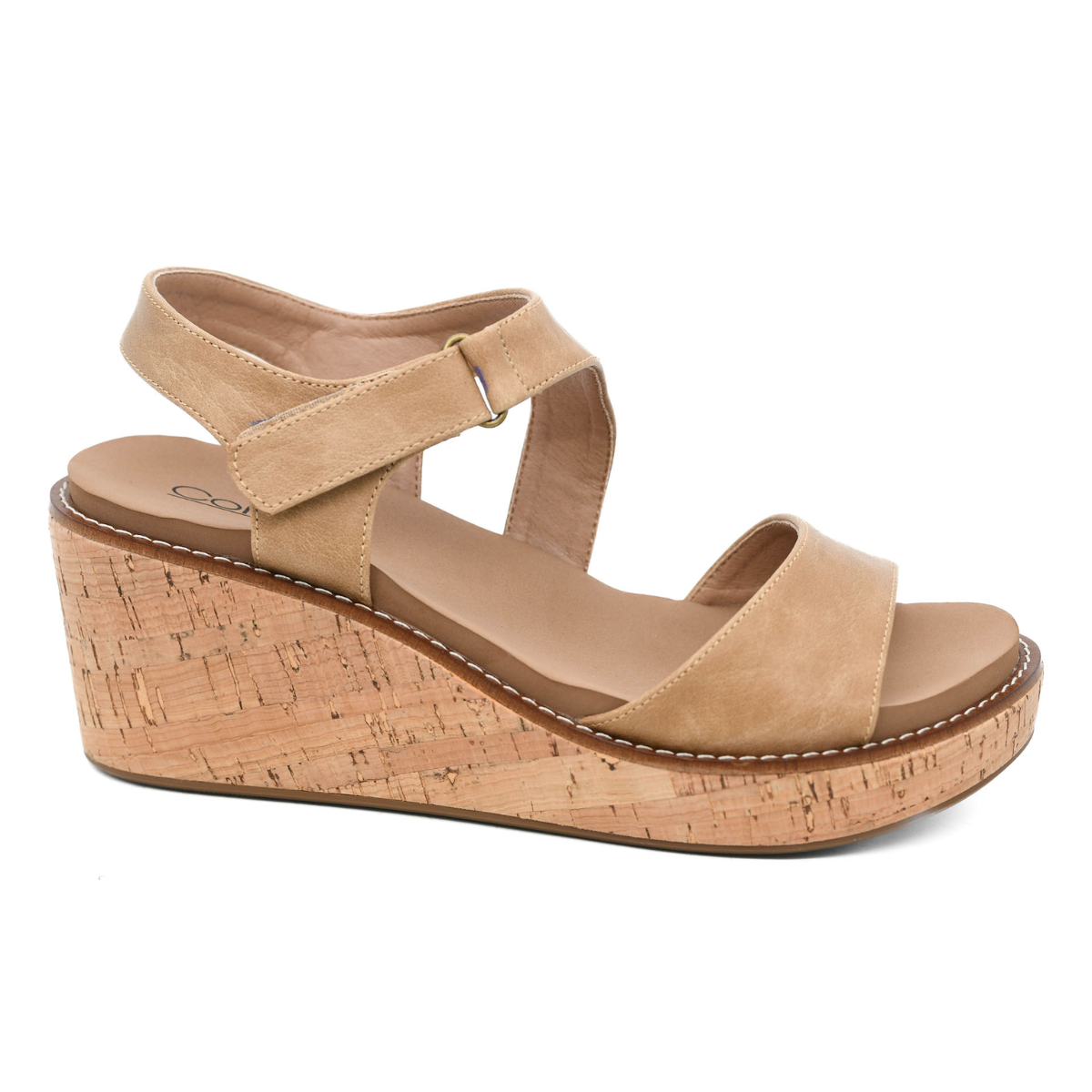 The Five O'clock Somewhere Wedge Sandal in Taupe by Corky's features wedge styling, an ankle strap, and a cork platform sole. Available in whole sizes only.