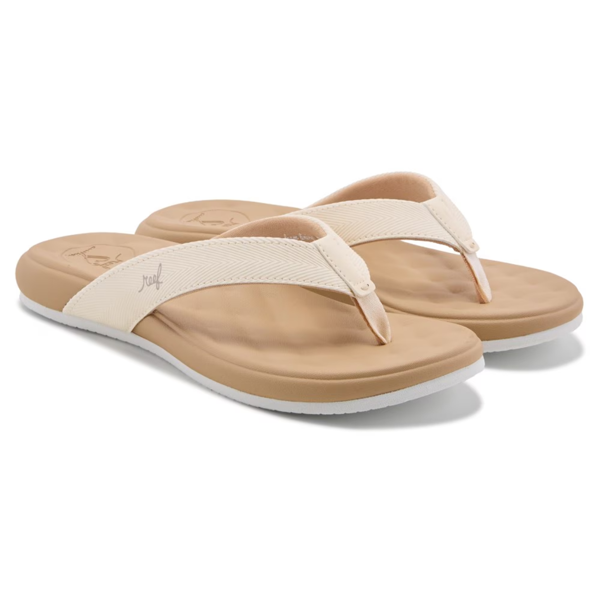 The Cushion Melody Flip Flops in Sand by REEF are beige flip-flops with white straps and tan footbeds, featuring a cushy textured surface for comfort and support, enhanced with memory foam. Main image