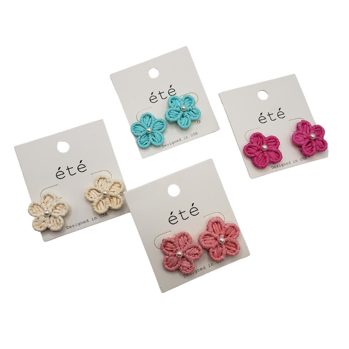 Four pairs of Rattan Flower Earrings by SPECIAL EFFECTS showcase this season's trend, featuring blue, pink, white, and coral flowers with pearl centers. Some styles have subtle rattan accents for a touch of natural elegance. Main image