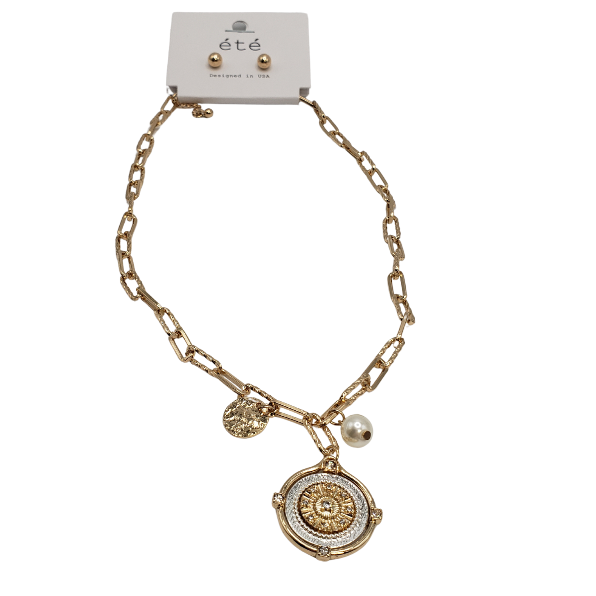 The SPECIAL EFFECTS 2 Tone Disc and Pearl Pendant Necklace Set features a gold chain necklace with a large round pendant, pearl accent, and disc charm. It includes matching stud earrings on an "été" card. Main image