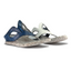 The MODZORI Lirah #4 Reversible Navy to White shoes feature textured blue and white uppers, cutout details, decorative stitching, and speckled flat soles for an asymmetrical look.