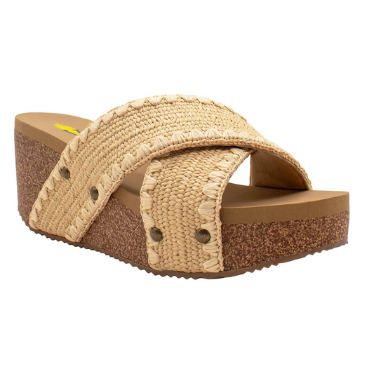 The Antiqua Wedge Slide Sandal in Natural by PV Footwear features a straw-textured crisscross upper, a brown cork-like platform sole, and an EVA insole for comfort.