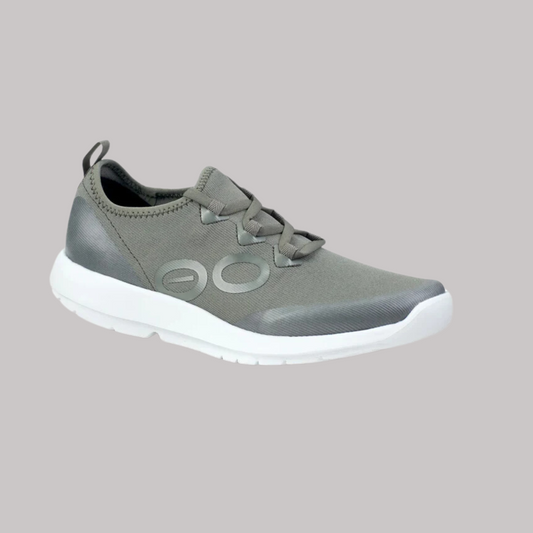 The olive athletic shoe with a white sole showcases a loop at the heel and a stylized "OO" logo, featuring OOfoam™ technology for superior active recovery. Perfectly blending style and function, the OOFOS Sport Lace Womens Olive is designed for comfort and performance.