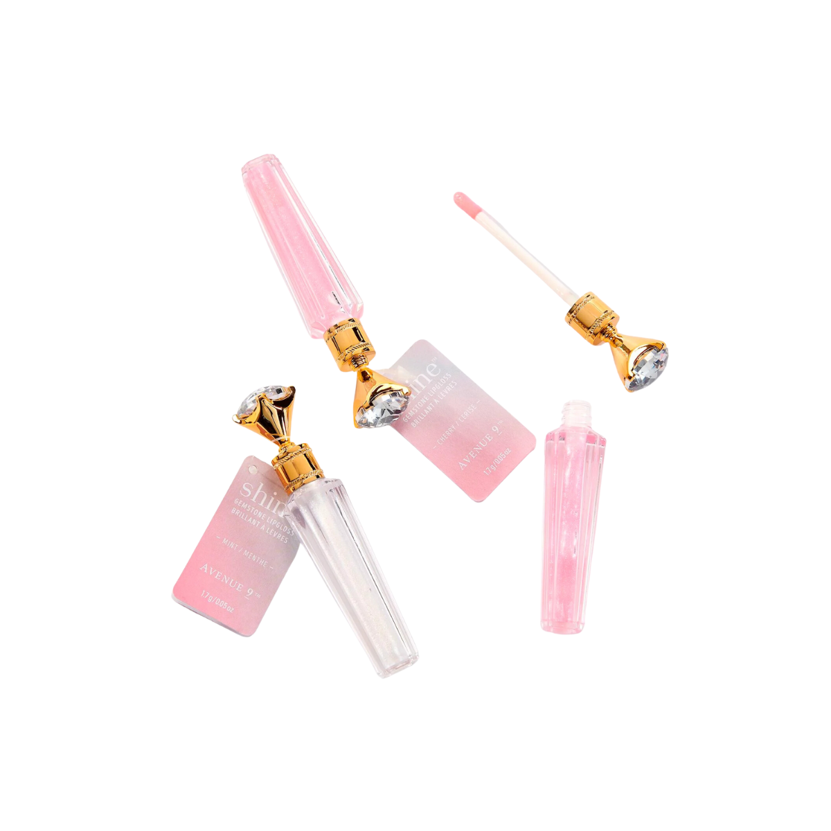 Two ornate Shine Gemstone Lip Gloss tubes by GIFTCRAFT, in pink and clear with luxurious gold caps, one open with the wand beside it, are displayed on a white background. These tubes promise shimmering glossy color for a touch of elegance. Main image