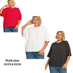A woman models the Zenana Double Knit Short Sleeve Top in red, white, and dark gray with jeans. Available in plus sizes 1X/2X and 2X/3X.
