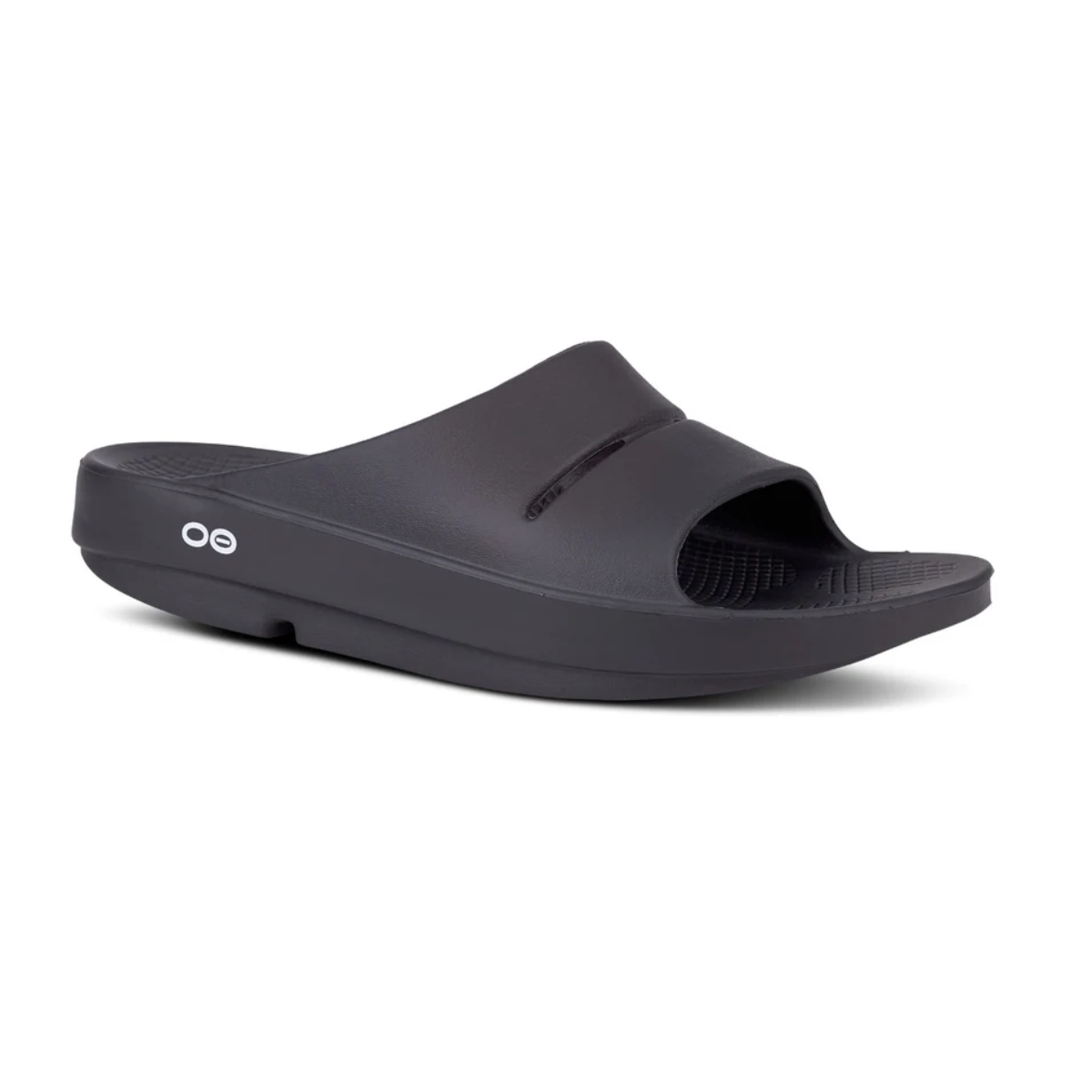 The OOFOS Ooahh Slide by OOFOS LLC is a black slide sandal with a thick sole, open toe, side logo, and patented footbed design providing superior recovery comfort. Main image