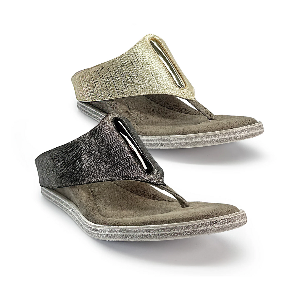 The Iris #1 Reversible Wedge Sandals by Flipflops & Whatnots showcase a chic metallic textured design in gold and pewter. Made from vegan leather, they combine style with sustainability through their versatile T-strap and flat sole construction.
