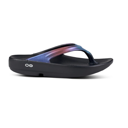 A side view of the OOFOS OOLALA MAGENTA SKY recovery sandal by OOFOS LLC, featuring a thick sole and stylish two-tone purple and pink straps, perfect for everyday wear with a feminine silhouette.