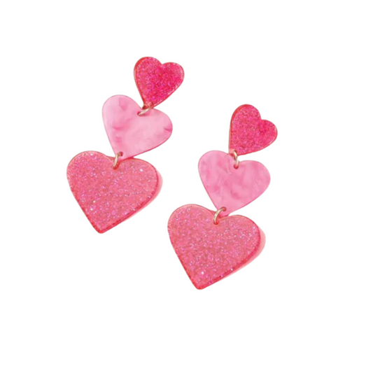 The swaary "String of Hearts Glitter Earrings" feature festive pink and red dangles adorned with glitter resin and marbled heart patterns.