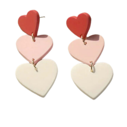 The swaary String of Hearts Solid Earrings feature heart-shaped designs in red, pink, and white stacked vertically for a playful look.