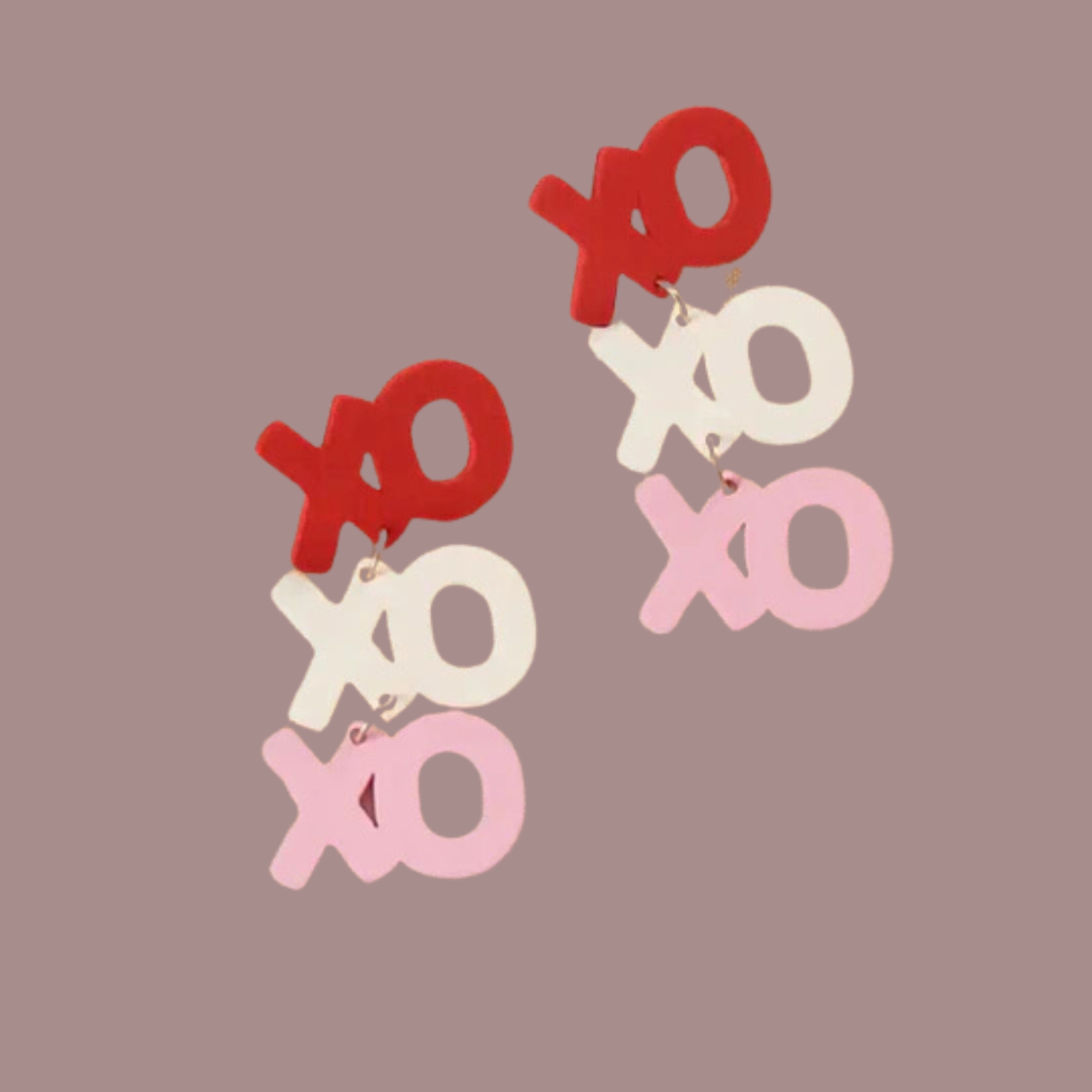 These XOXO Earrings by swaary feature a delightful red, cream, and pink "XO" pattern on a plain backdrop. Ideal for any occasion, these dangling earrings add a playful touch to your style.