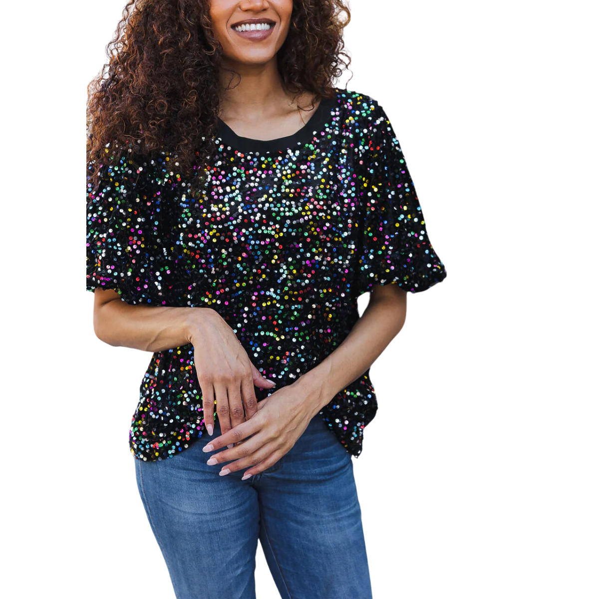 A woman in a Bloom Wholesale Holiday Black Velvet Multi Colored Puff Sleeve Sequin Top and jeans stands with her hands lightly clasped, smiling against a plain white background.