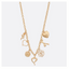 The Heart and Flower Charm Necklace by FASHION GO features six assorted charms—a flower, two hearts, a rose, a daisy, and a cupid—on gold metal, adding playful elegance to any outfit. Displayed on a plain white background.
