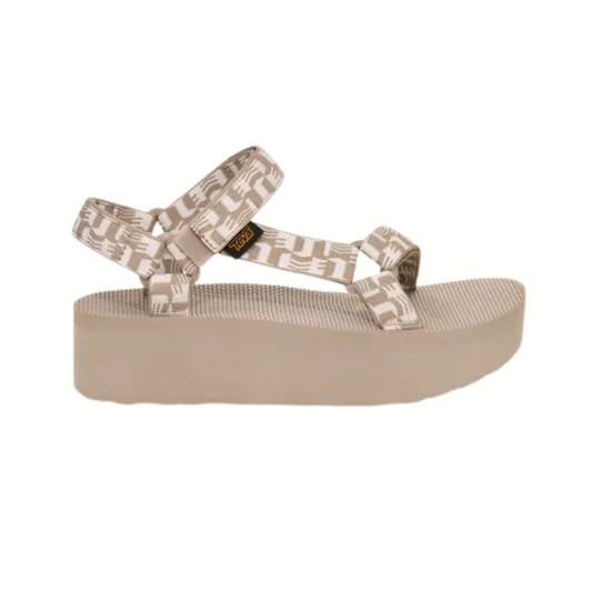 The TEVA Flatform Universal Glisten in Simply Taupe features patterned recycled polyester straps, an adjustable ankle buckle, and a thick textured sole. Shown on a white background, this vegan sandal blends comfort and eco-conscious style.