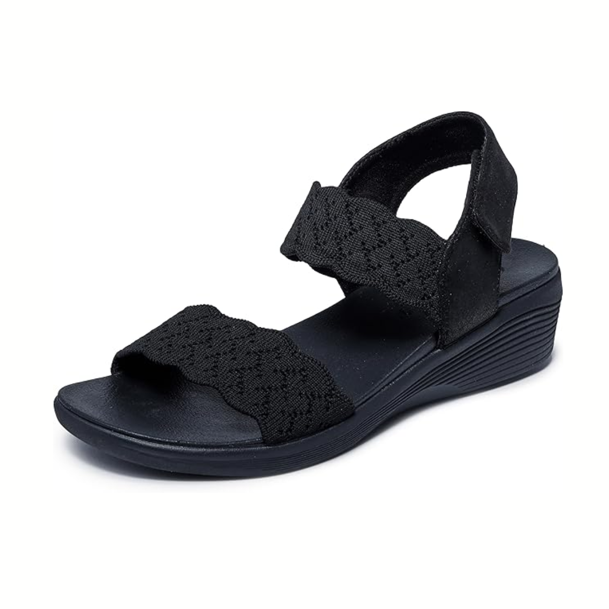 The Arya on the Rise in Black by SKECHERS USA INC is a black open-toe vegan sandal with textured fabric straps, adjustable backstrap, low wedge heel, and cushioned Luxe Foam for comfort, shown on a white background.