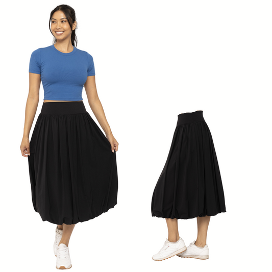 A woman models the FASHION GO Midi Bubble Skirt in black with a blue top and white sneakers. The side view highlights the skirt’s flow, all set against a white background—ideal for an active lifestyle.