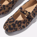 Close-up of Fit Flops' Delicato Leather Mary Janes in Leopard—comfortable nappa leather flats with a single strap and gold buckle, showcased on a neutral background.
