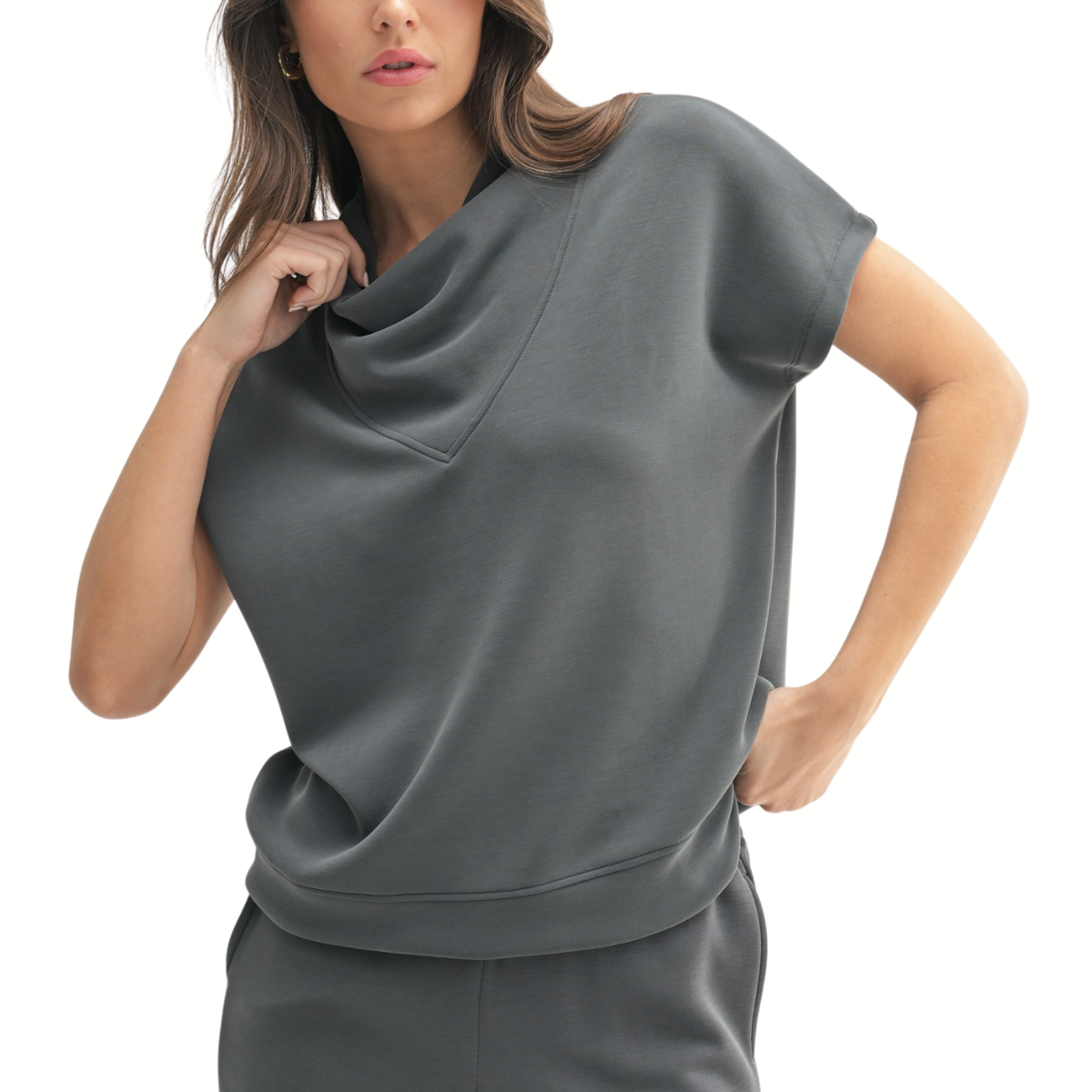 Wearing the Mono B Laguna Cowl Neck Wide Leg Pant Set—a loose, short-sleeved dark gray top with a cowl neck and matching wide-leg pants—a person stands against a white background.