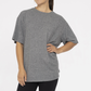 Model stands against a white background wearing the Mono B Brushed Hacci Boyfriend Tee and Wide Leg Pant Set, with one hand on their hip.