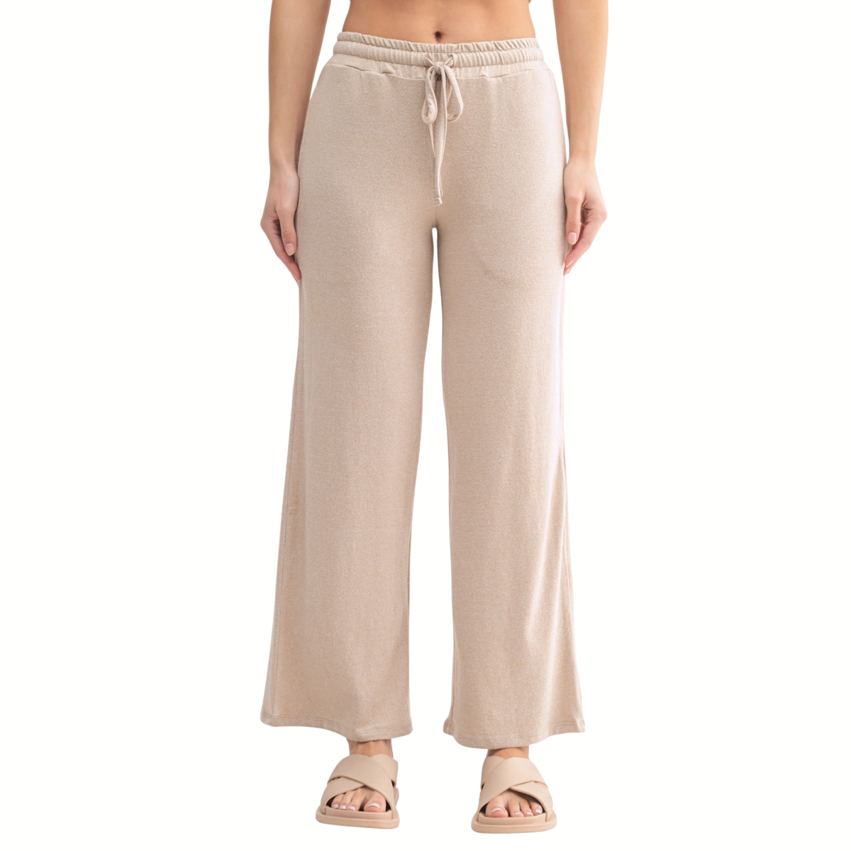A person wears the Mono B Brushed Cowl Neck Lounge Pullover and Wide Leg Lounge Pant Set in beige, paired with beige sandals, shown from the waist down against a white background.