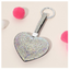 The Wona Trading Bling Heart Key Chain Bag Charm, covered in iridescent rhinestones and available in assorted colors, makes a perfect sparkly accessory for your bag.