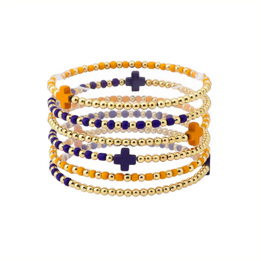The Gameday Orange and Navy Beaded Stretch Bracelets by What's Hot feature gold, orange, navy, and white beads with cross accents—ideal for elevating your gameday look.