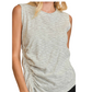 A woman wearing the Umgee Striped Sleeveless Shirred Top featuring ruched and shirred details.