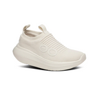 The OO My Zen in Chalk by OOFOS LLC is a beige slip-on sneaker with a knitted, ribbed texture, two oval decorations, and a pull tab. It has a chunky sole with OOfoam technology for enhanced comfort and is designed as an active recovery shoe.