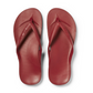 A pair of Archies Flip Flops in Sangria by ARCHIES FOOTWEAR LLC with textured footbeds, made from closed cell foam, seen from above on a white background.