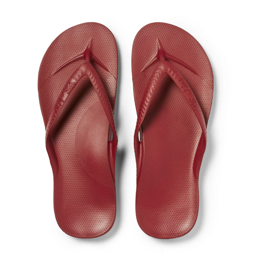 A pair of Archies Flip Flops in Sangria by ARCHIES FOOTWEAR LLC with textured footbeds, made from closed cell foam, seen from above on a white background.