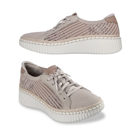 Two taupe SKECHERS Breezy Stroll Slip On Tennis Shoes with knit texture, patterned side panels, and thick white ribbed soles featuring Air-Cooled Memory Foam are displayed against a white background.