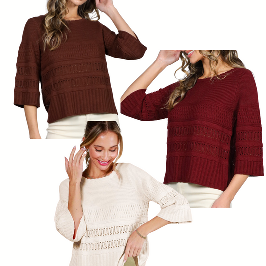 Three women wear Vine & Love's 3/4 Sleeve Sweaters in brown, burgundy, and cream, featuring cozy textured fabric and horizontal patterns in a relaxed fit, each styled with light-colored pants.