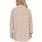 A person with long blonde hair is shown from behind wearing the FASHION GO Cotton Long Sleeve Button Down, a loose-fitting shirt in a beige plaid pattern.