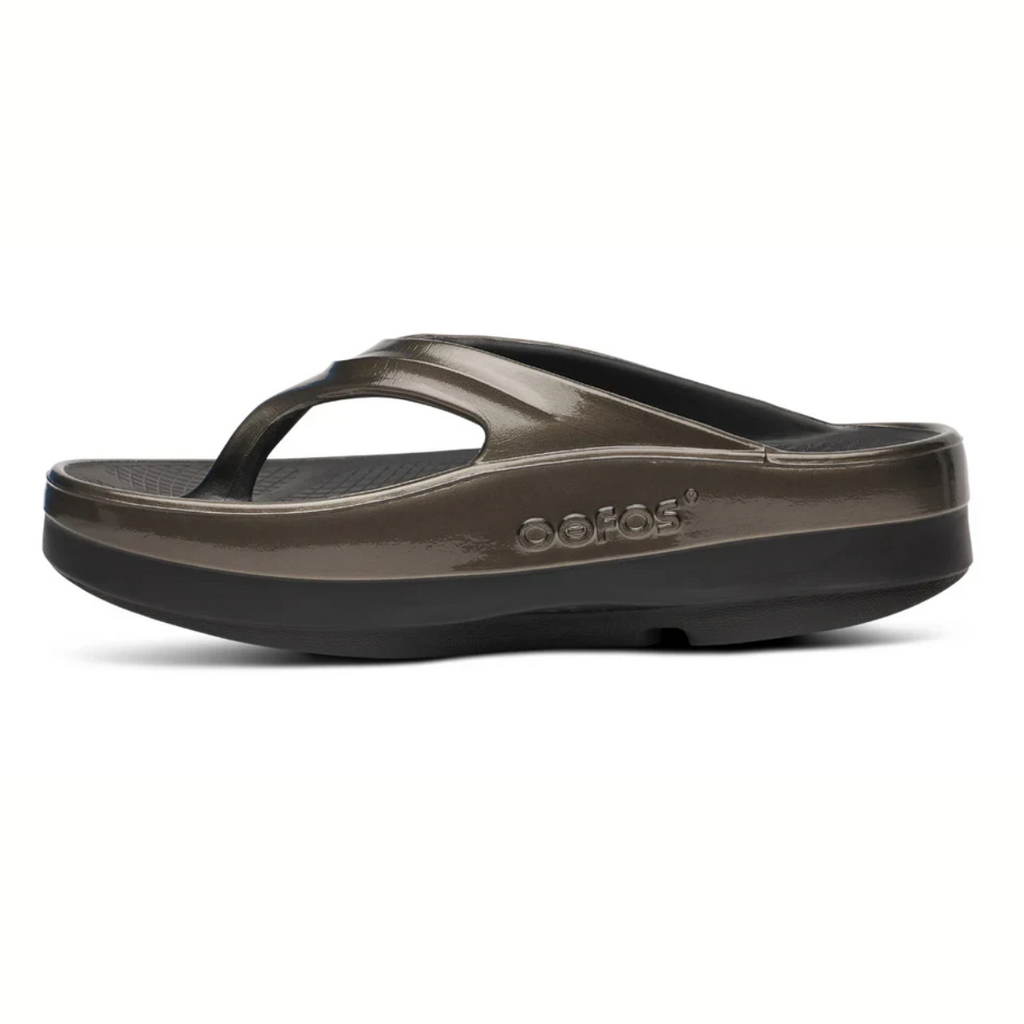 Side view of a single OOFOS LLC OOmega OOlala sandal in Titanium Mirror, showing its thick cushioned OOfoam™ sole for enhanced comfort and arch support, set against a white background.