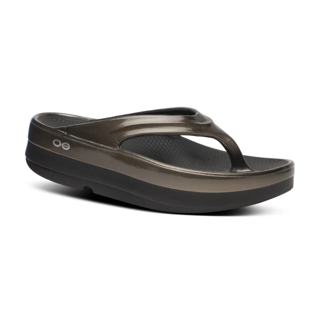 A single OOfos OOmega OOlala flip-flop sandal in Titanium Mirror by OOFOS LLC, featuring a thick sole, toe strap, and OOfoam™ technology for superior cushioning and arch support, shown on a white background.