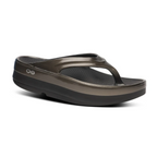 A single OOfos OOmega OOlala flip-flop sandal in Titanium Mirror by OOFOS LLC, featuring a thick sole, toe strap, and OOfoam™ technology for superior cushioning and arch support, shown on a white background.