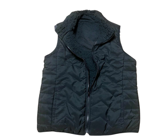 The Quilted Vest with Sherpa Lining by RONNIE SALLOWAY & CO INC, featuring a high collar and zipper along with a soft interior, is an essential layering piece for any wardrobe.