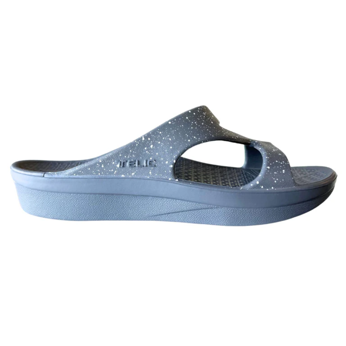 A Z-Strap Gray/White Recovery Sandal by Telic with a cutout design, thick sole, glitter accents, and cushioning for added comfort.