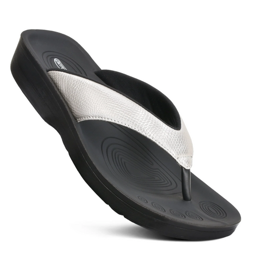 A comfortable pair of women's Meira In Silver flip flop sandals by Aerothotic with black and silver accents.