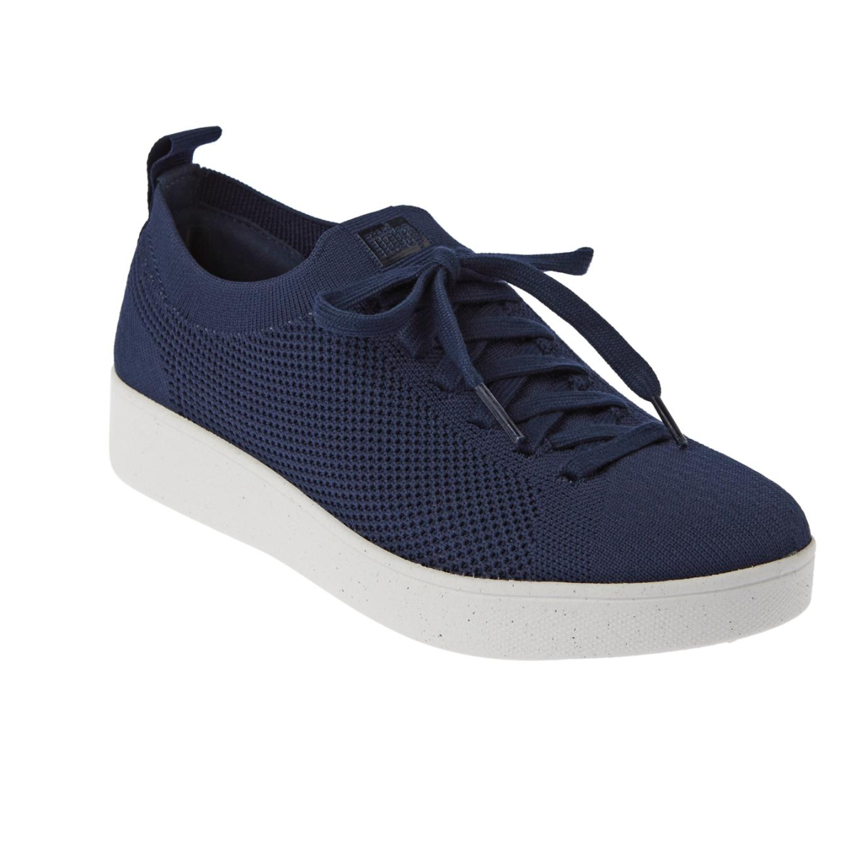 Introducing the Rally Knit Tennis Shoe in Navy by FIT FLOPS from FITFLOP USA LLC, a sleek dark blue sneaker with a white sole, navy laces, and a convenient pull tab at the back. Crafted from engineered knit for eco-friendly footwear. Main image