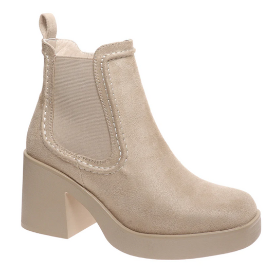 The Garnet 1 Suede Boot in Wheat by Pierre Dumas features a tan suede ankle design with a block heel, elastic side panel, and square toe. These booties from OLEM SHOE CORP include a convenient zip-up closure and a pull tab at the back.