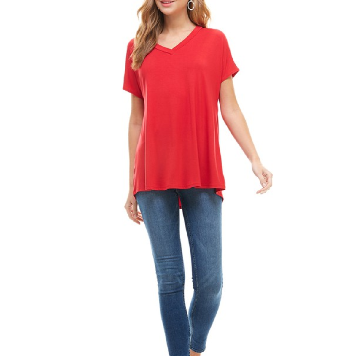 A person is wearing a red Basic Cap Sleeve V-Neck Tunic from FASHION GO with blue skinny jeans. Main image