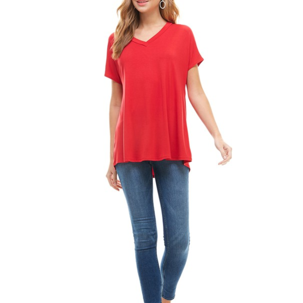 A person is wearing a red Basic Cap Sleeve V-Neck Tunic from FASHION GO with blue skinny jeans.