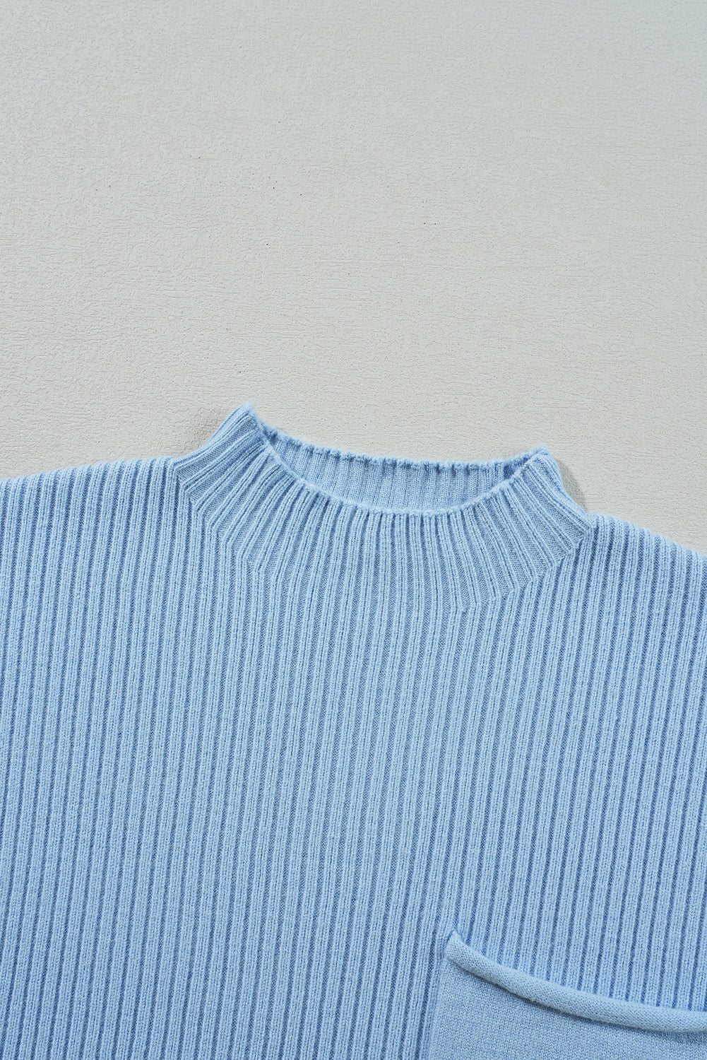 A Patch Pocket Ribbed Knit Short Sleeve Sweater by Shewin in light blue, featuring a round neck and visible pocket, ideal for transitional weather.