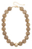 The Marjorie Fall Beaded Necklace by Canvas Style features chunky, brown marbled resin beads accented with a statement gold bead at the center and is finished with an adjustable gold chain clasp.