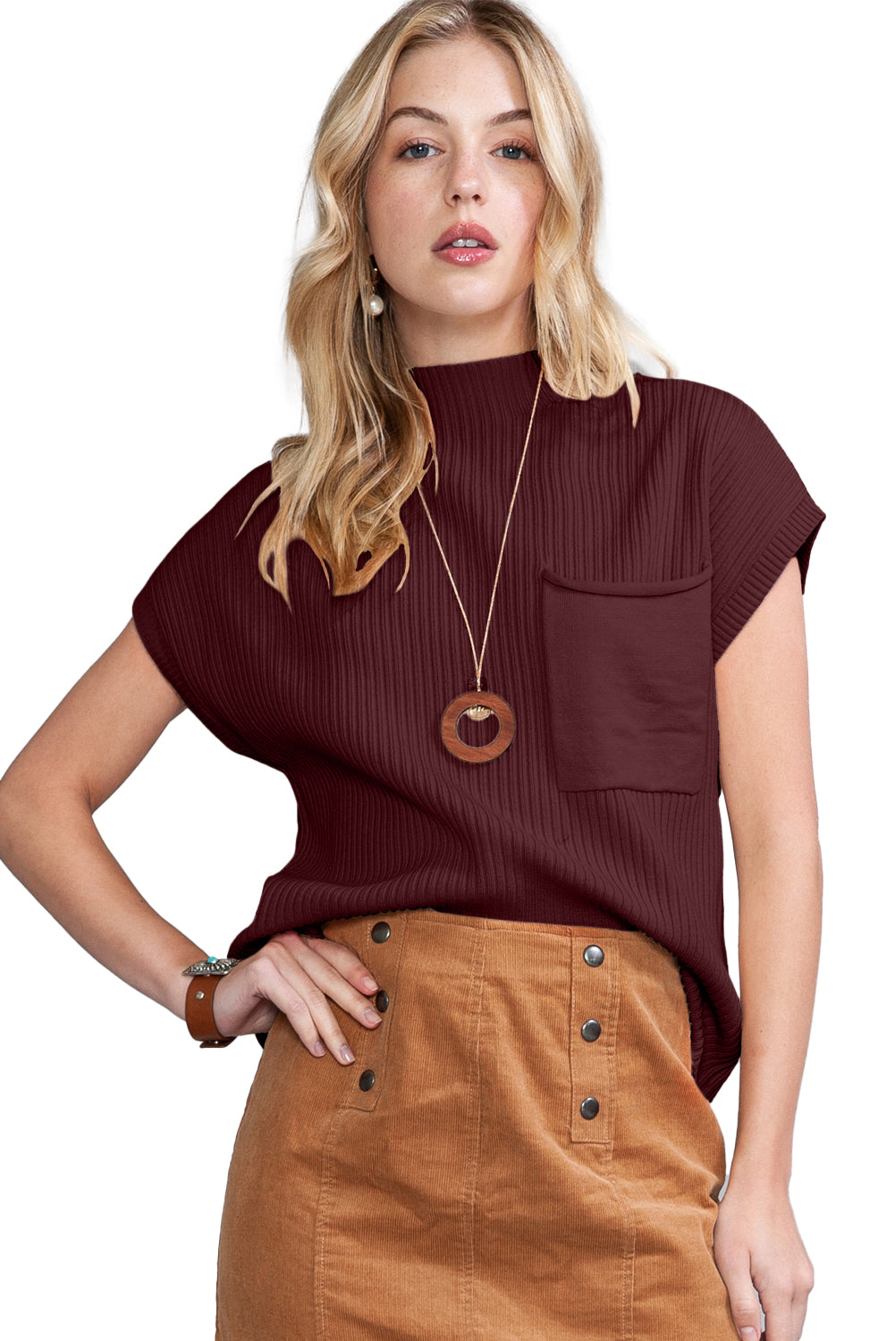 A woman wears a burgundy top and brown buttoned skirt, accessorized with a wooden necklace and bracelet, ideally paired with Shewin's Patch Pocket Ribbed Knit Short Sleeve Sweater for modern casual style in transitional weather.