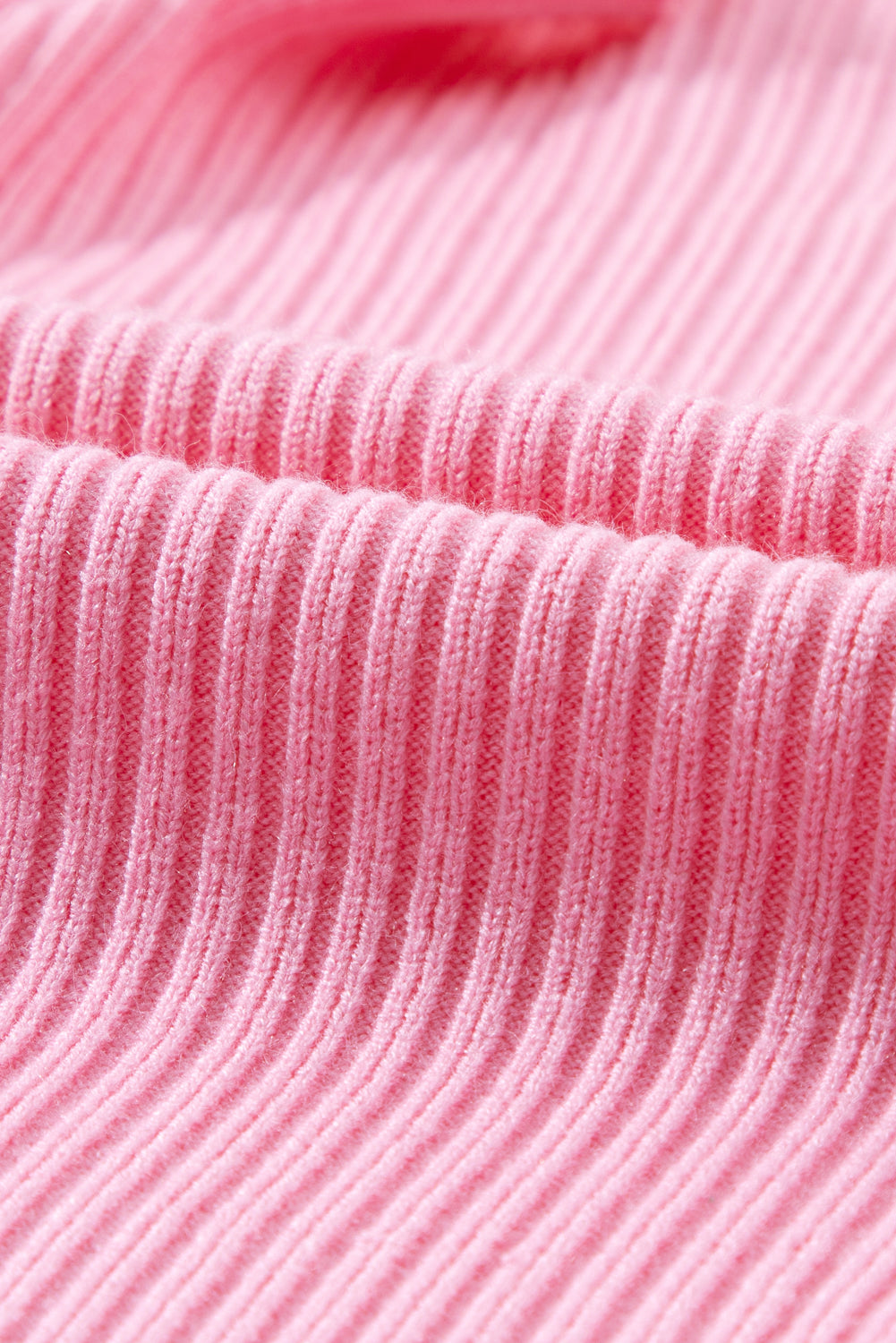 Close-up of the Patch Pocket Ribbed Knit Short Sleeve Sweater by Shewin in pink, with a soft texture ideal for transitional weather.