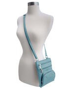 A mannequin displays the Roma Leathers, Inc. Cowhide leather Crossbody with phone pocket back side, featuring multiple zippered compartments and an adjustable shoulder strap, set against a white background.