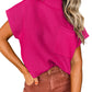 A person wears the Patch Pocket Ribbed Knit Short Sleeve Sweater by Shewin in vibrant pink, paired with brown pants. Their wavy hair and colorful bracelets make it ideal for transitional weather.