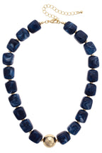 Palermo Resin Beaded Necklace in blue marbled resin with gold-toned spacers, a central gold sphere, and a lobster claw clasp.
